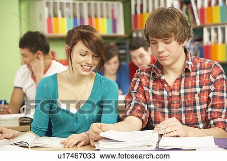Stock Image - Teenage Students Studying In Classroom. Fotosearch