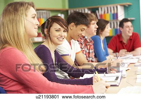 Stock Image - Teenage Students Studying In Classroom. Fotosearch