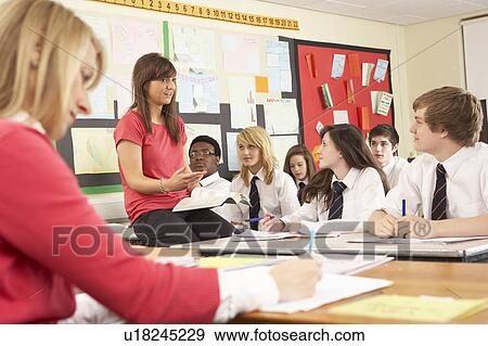 Teenage Students Studying In Classroom With Teacher And Assistan View Large Photo Image Stock Photo - Teenage Students Studying In Classroom With Teacher And Assistan. Fotosearch