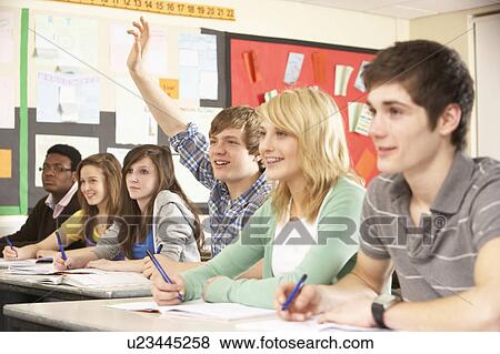 Teenage Students Studying In Classroom Answering Question View Large Photo Image Stock Photo - Teenage Students Studying In Classroom Answering Question. Fotosearch