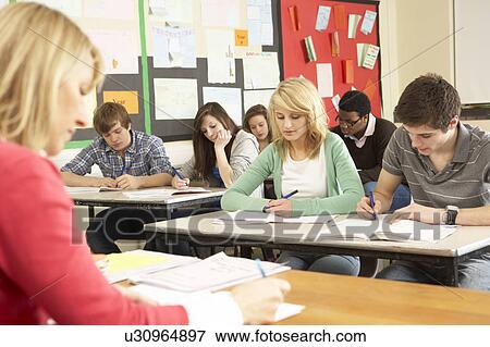 Teenage Students Studying In Classroom With Teacher View Large Photo Image Stock Photo - Teenage Students Studying In Classroom With Teacher. Fotosearch