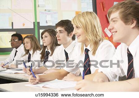 Stock Photograph - Teenage Students Studying In Classroom. Fotosearch