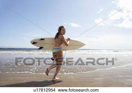 Teenager girl with surfboard View Large Photo Image Picture - Teenager girl with surfboard. Fotosearch