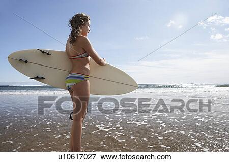 Stock Photo - Teenager girl with surfboard. Fotosearch