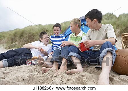 Stock Photo - Teenagers having picnic. Fotosearch