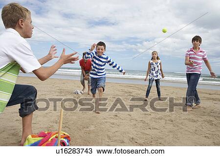 Teenagers playing baseball on beach View Large Photo Image Stock Image - Teenagers playing baseball on beach. Fotosearch