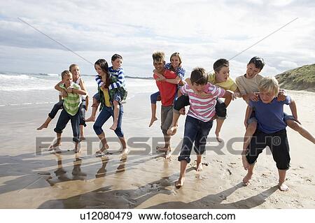 Stock Photo - Teenagers playing piggyback. Fotosearch