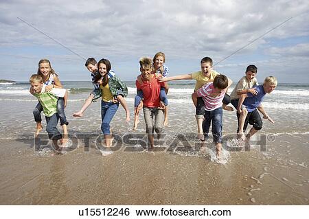 Stock Photograph - Teenagers playing piggyback. Fotosearch