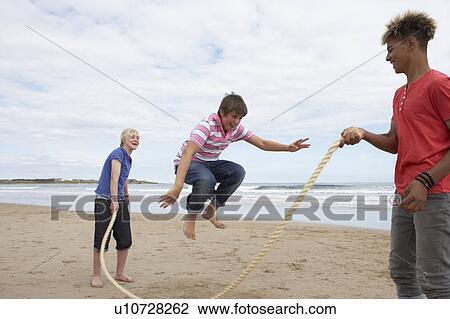 Teenagers playing skipping rope View Large Photo Image Stock Image - Teenagers playing skipping rope. Fotosearch