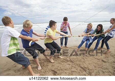 Stock Image - Teenagers playing tug of war. Fotosearch