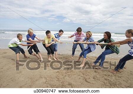 Stock Photo - Teenagers playing tug of war. Fotosearch