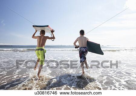 Teenagers surfing View Large Photo Image Stock Photograph - Teenagers surfing. Fotosearch