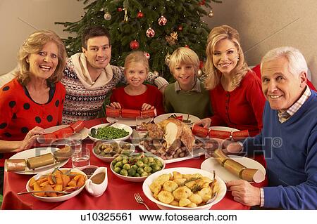 Three Generation Family Enjoying Christmas Meal At Home View Large Photo Image Stock Image - Three Generation Family Enjoying Christmas Meal At Home. Fotosearch