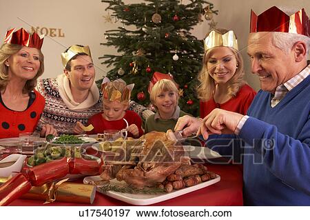 Three Generation Family Enjoying Christmas Meal At Home View Large Photo Image Stock Photo - Three Generation Family Enjoying Christmas Meal At Home. Fotosearch