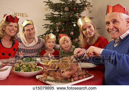 Three Generation Family Enjoying Christmas Meal At Home View Large Photo Image Stock Photography - Three Generation Family Enjoying Christmas Meal At Home. Fotosearch