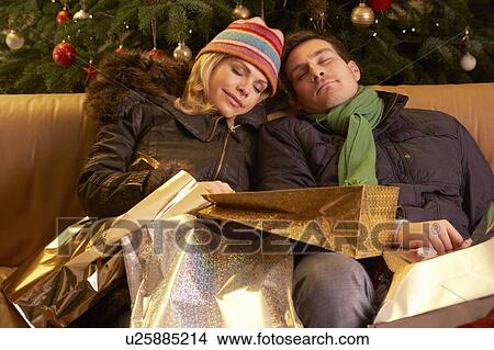 Tired Couple Returning After Christmas Shopping Trip View Large Photo Image Picture - Tired Couple Returning After Christmas Shopping Trip. Fotosearch