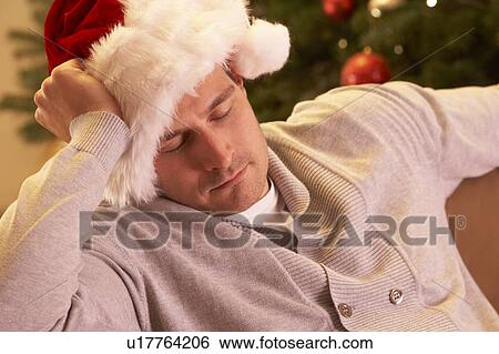 Tired Man Relaxing In Front Of Christmas Tree View Large Photo Image Stock Photograph - Tired Man Relaxing In Front Of Christmas Tree. Fotosearch