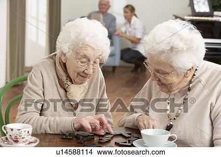 Two Senior Women Playing Dominoes At Day Care Centre View Large Photo Image Picture - Two Senior Women Playing Dominoes At Day Care Centre. Fotosearch