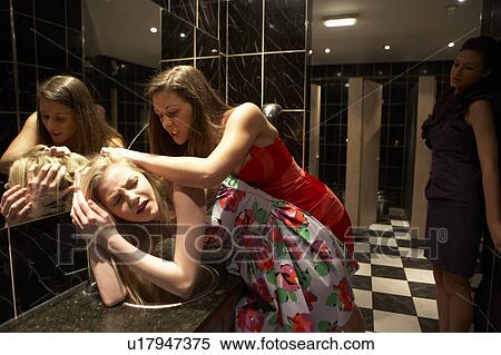 Two women having a fight in bathroom View Large Photo Image Stock Photography - Two women having a fight in bathroom. Fotosearch