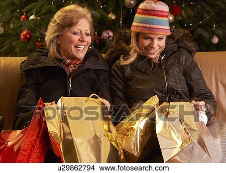 Picture - Two Women Returning After Christmas Shopping Trip. Fotosearch