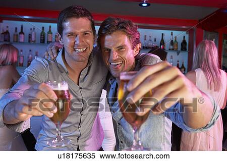 Two Young Men Having Fun In Busy Bar View Large Photo Image Stock Photography - Two Young Men Having Fun In Busy Bar. Fotosearch