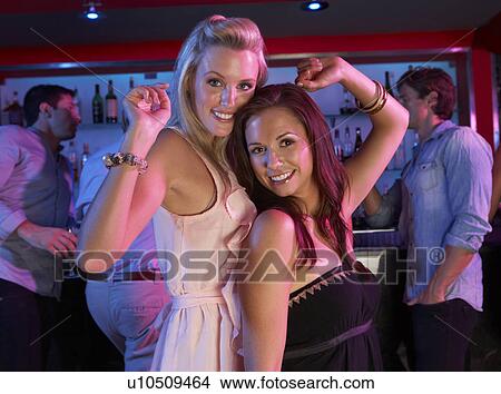 Two Young Women Having Fun In Busy Bar View Large Photo Image Picture - Two Young Women Having Fun In Busy Bar. Fotosearch