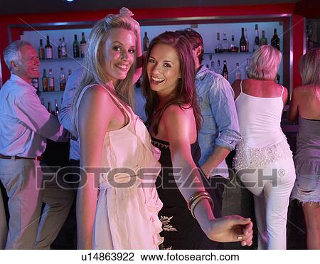 Two Young Women Having Fun In Busy Bar View Large Photo Image Stock Image - Two Young Women Having Fun In Busy Bar. Fotosearch