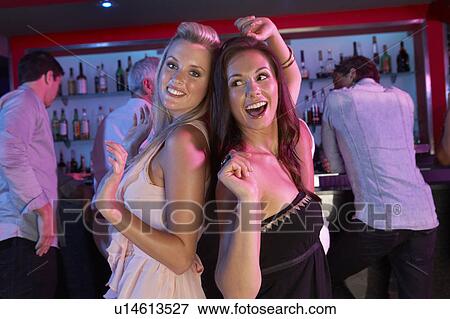 Two Young Women Having Fun In Busy Bar View Large Photo Image Stock Photo - Two Young Women Having Fun In Busy Bar. Fotosearch