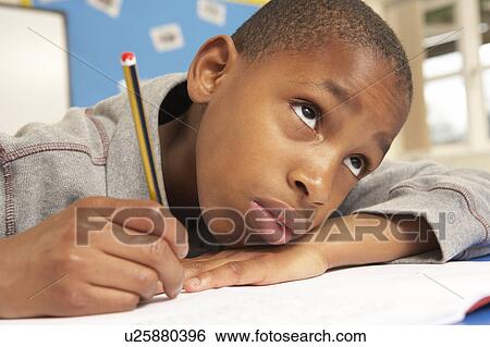 Unhappy Schoolboy Studying In Classroom View Large Photo Image Stock Photograph - Unhappy Schoolboy Studying In Classroom. Fotosearch
