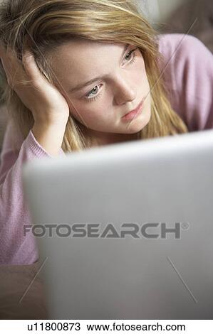 Unhappy Teenage Girl Using Laptop At Home View Large Photo Image Stock Image - Unhappy Teenage Girl Using Laptop At Home. Fotosearch