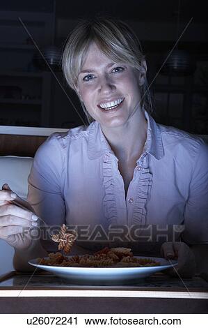 Woman Enjoying Meal Whilst Watching TV View Large Photo Image Stock Image - Woman Enjoying Meal Whilst Watching TV. Fotosearch
