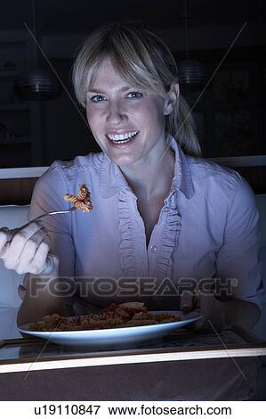 Woman Enjoying Meal Whilst Watching TV View Large Photo Image Stock Photo - Woman Enjoying Meal Whilst Watching TV. Fotosearch