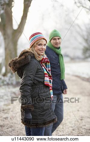 Stock Image - Woman On Winter Walk Through Frosty Landscape. Fotosearch