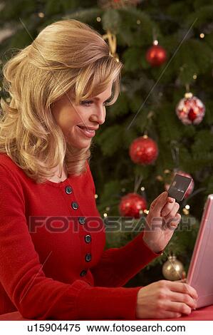 Stock Photography - Woman Shopping Online For Christmas Gifts. Fotosearch