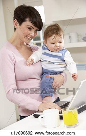Woman With Baby Working From Home Using Laptop View Large Photo Image Stock Image - Woman With Baby Working From Home Using Laptop. Fotosearch
