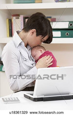 Woman With Newborn Baby Working From Home Using Laptop View Large Photo Image Stock Photo - Woman With Newborn Baby Working From Home Using Laptop. Fotosearch