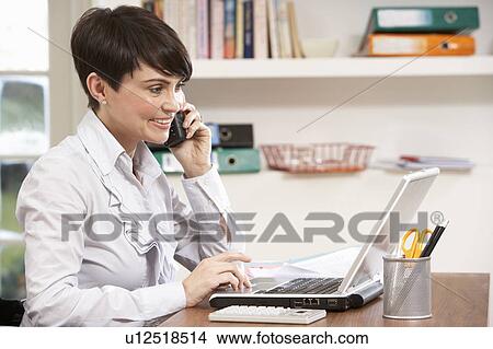 Woman Working From Home Using Laptop On Phone View Large Photo Image Picture - Woman Working From Home Using Laptop On Phone. Fotosearch