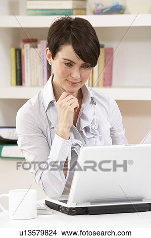 Woman Working From Home Using Laptop View Large Photo Image Picture - Woman Working From Home Using Laptop. Fotosearch