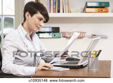 Stock Photo - Woman Working From Home Using Laptop. Fotosearch