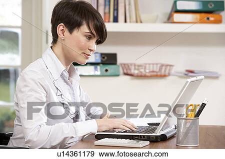 Stock Photo - Woman Working From Home Using Laptop. Fotosearch