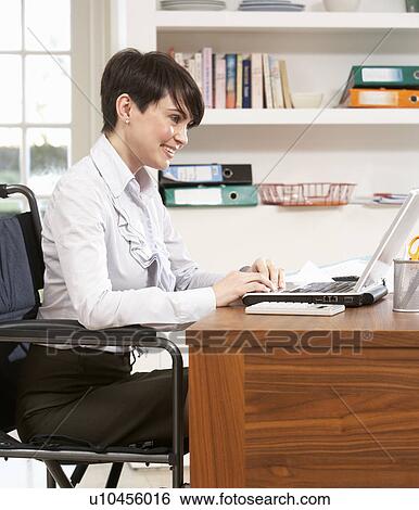 Stock Photograph - Woman Working From Home Using Laptop. Fotosearch