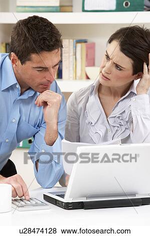 Worried Couple Working From Home Using Laptop View Large Photo Image Stock Photo - Worried Couple Working From Home Using Laptop. Fotosearch