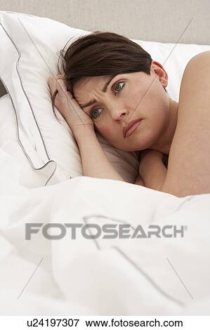Stock Photo - Worried Woman Laying Awake In Bed. Fotosearch