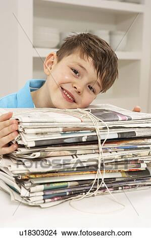 Picture - Young Boy Recyling Newspapers At Home. Fotosearch