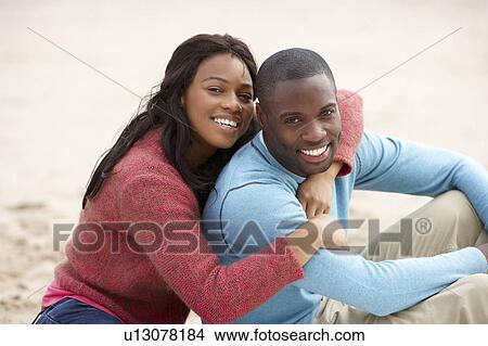 Picture - Young couple Embracing on beach. Fotosearch