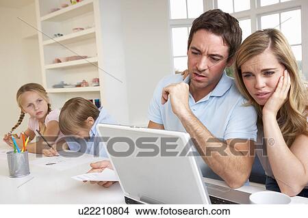 Young couple thinking and looking at a laptop computer View Large Photo Image Picture - Young couple thinking and looking at a laptop computer. Fotosearch