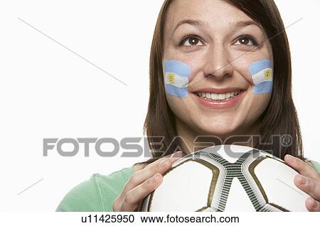 Stock Image - Young Female Football Fan With Argentinian Flag Painted On Face. Fotosearch