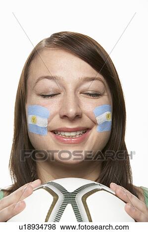 Stock Photo - Young Female Football Fan With Argentinian Flag Painted On Face. Fotosearch