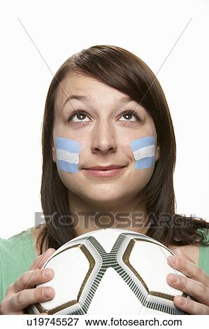 Stock Photo - Young Female Football Fan With Argentinian Flag Painted On Face. Fotosearch
