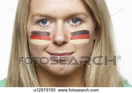 Stock Image - Young Female Sports Fan With German Flag Painted On Face. Fotosearch